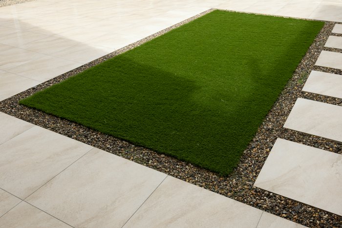 Green lawn between paved walkways