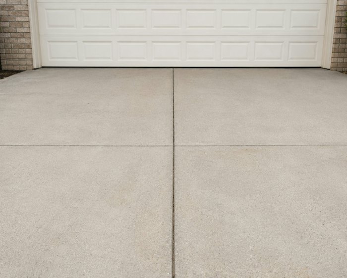 Smooth concrete driveway in front of a garage